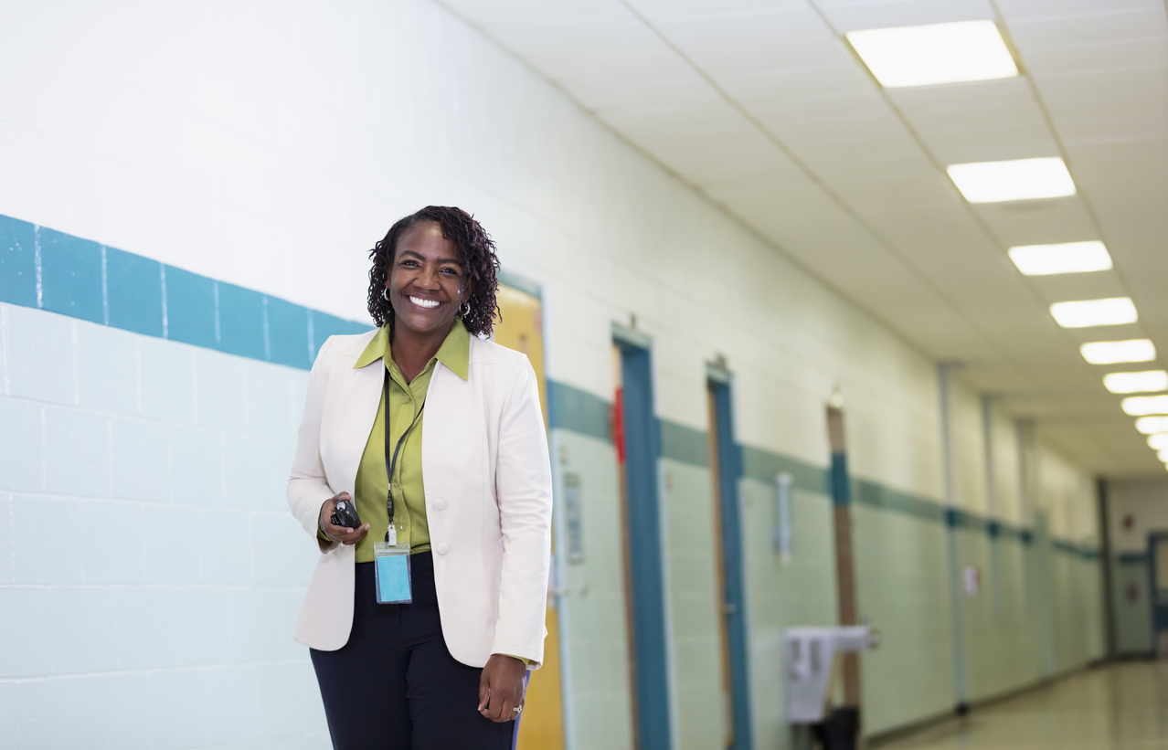 African-American female teacher in school hallway