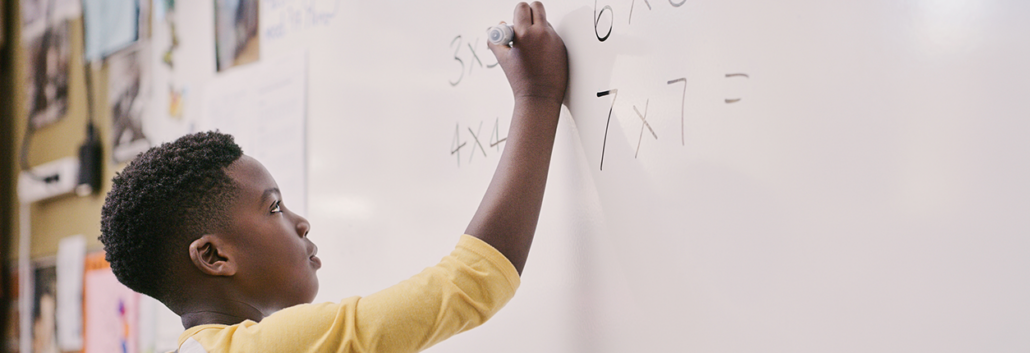 Math MTSS Student writing math problems on a whiteboard